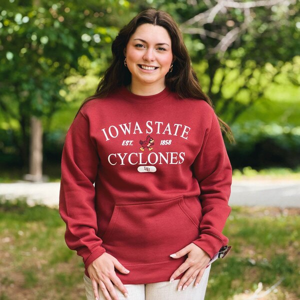 A student wearing CI Sport Walking Cy Cardinal Pocket Crewneck Sweatshirt